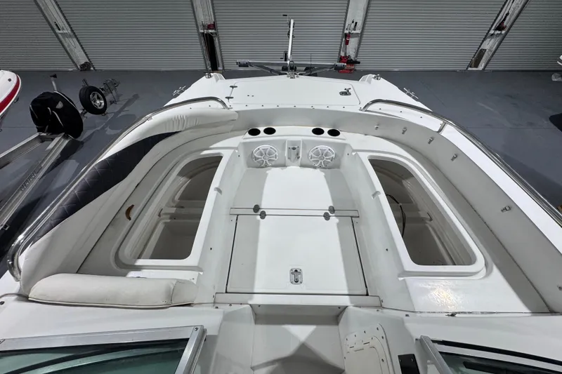 Slide: The Image of 2003 Glacier Bay 2640SX Renegade boat interior with storage compartments and speakers. - 31