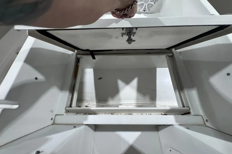 Slide: The Image of Open storage compartment on 2003 Glacier Bay 2640SX Renegade boat, showing interior details. - 34