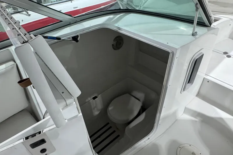 Slide: The Image of 2003 Glacier Bay 2640SX Renegade boat interior with compact marine toilet. - 36