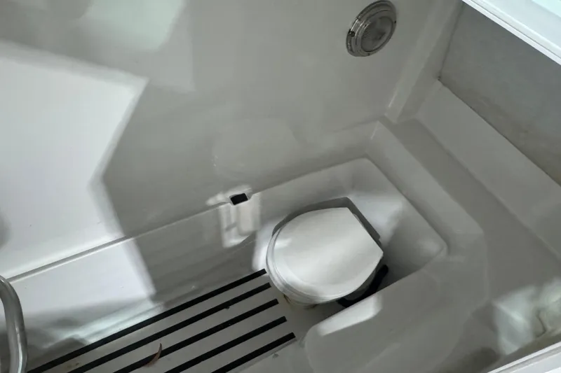 Slide: The Image of 2003 Glacier Bay 2640SX Renegade boat interior with compact marine toilet. - 37