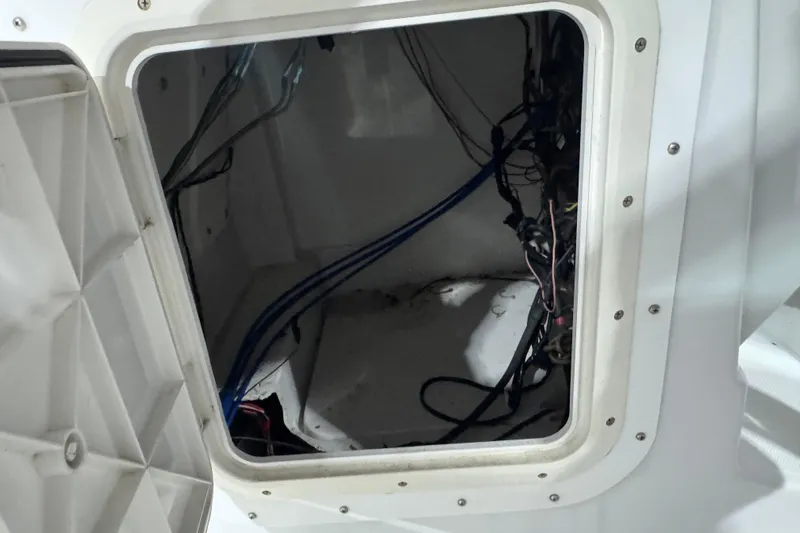 Slide: The Image of Open hatch with wiring inside a 2003 Glacier Bay 2640SX Renegade boat. - 39