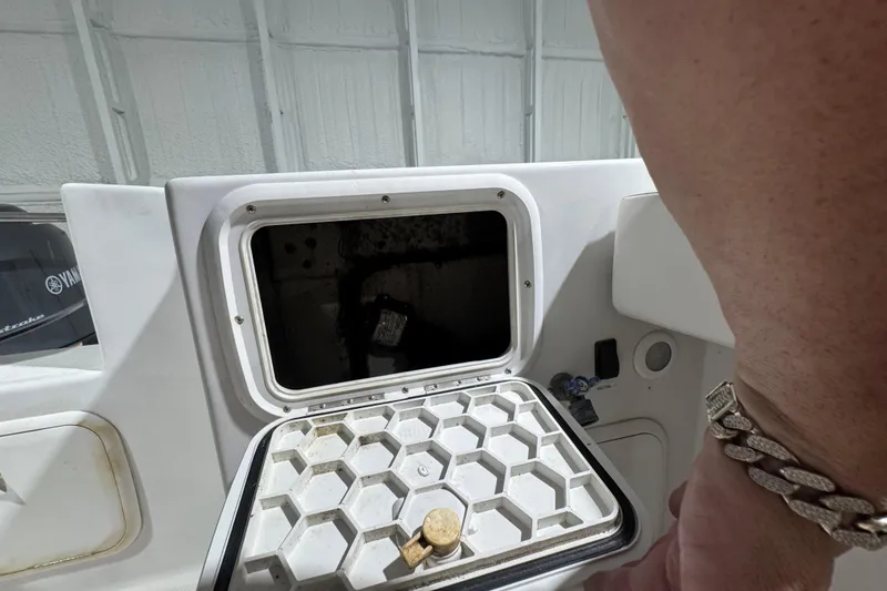 Slide: The Image of 2003 Glacier Bay 2640SX Renegade boat compartment with open hatch and visible interior. - 43