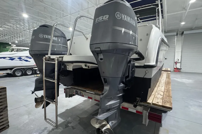 Slide: The Image of 2003 Glacier Bay 2640SX Renegade with dual Yamaha outboard motors in a warehouse. - 6