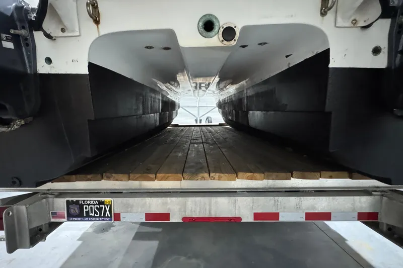 Slide: The Image of 2003 Glacier Bay 2640SX Renegade catamaran on trailer, rear view, Florida license plate. - 9