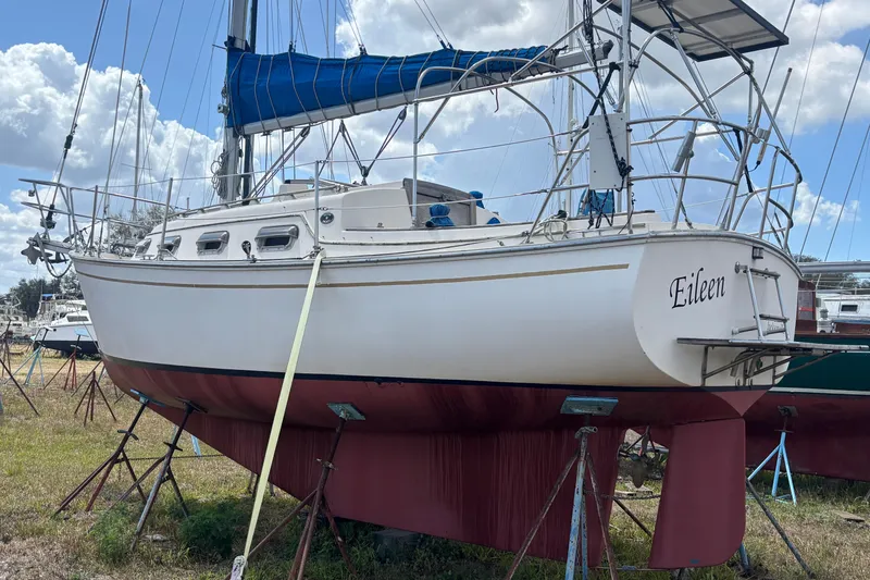 The Image of 1987 Island Packet 27 sailboat named "Eileen" on stands, with blue sail cover. - 1