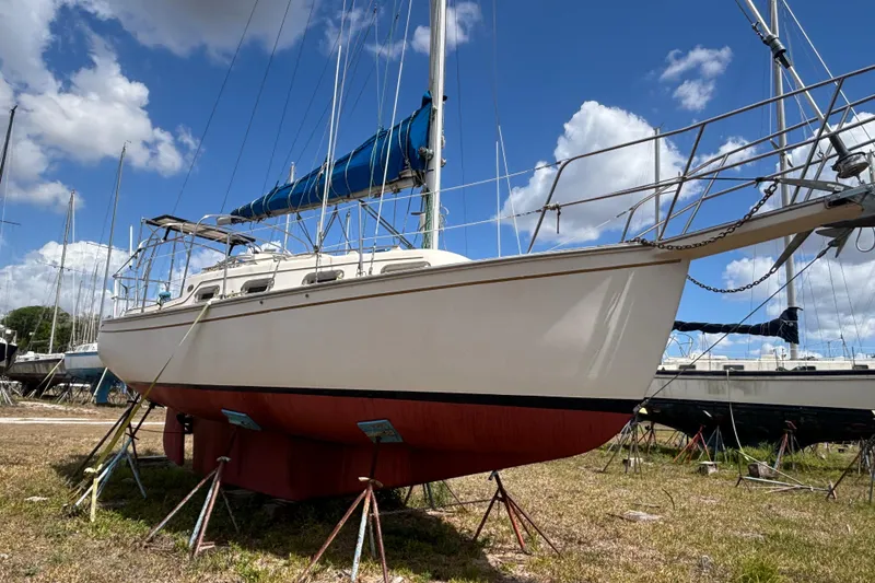 Slide: The Image of 1987 Island Packet 27 sailboat on land, blue sky background. - 3