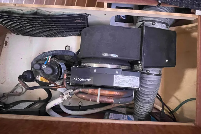 Slide: The Image of Dometic air conditioning unit in a 2006 Hunter 36 sailboat interior compartment. - 12