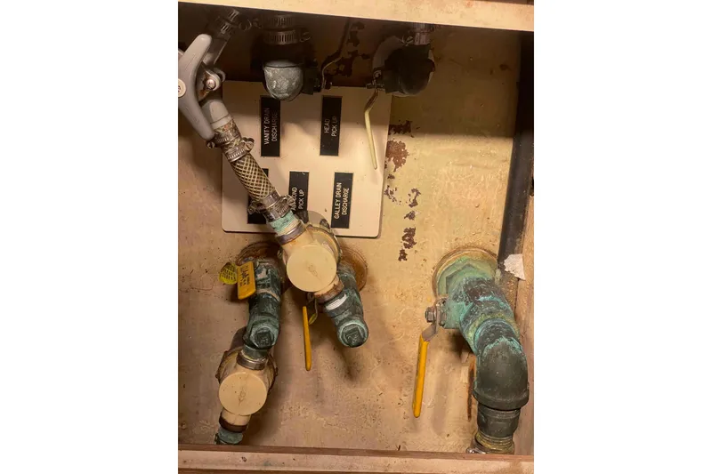Slide: The Image of Plumbing system in a 2006 Hunter 36 boat, featuring labeled valves and pipes. - 14