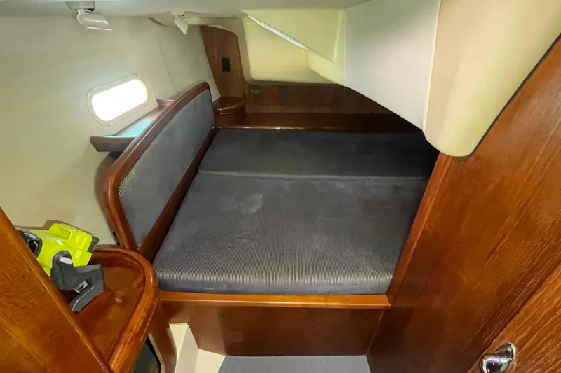 Slide: The Image of 2006 Hunter 36 yacht interior cabin with wooden finish and cozy bed. - 15