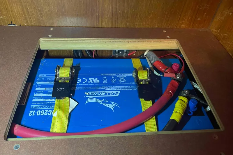 Slide: The Image of Battery compartment in a 2006 Hunter 36 sailboat, featuring a blue Fullriver battery. - 17
