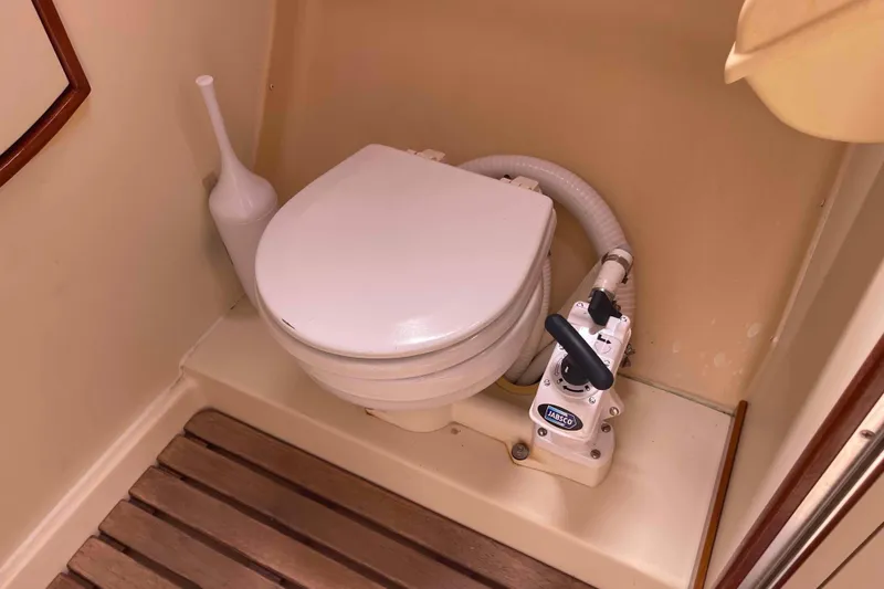 Slide: The Image of Marine toilet in 2006 Hunter 36 sailboat, featuring Jabsco pump and wooden floor. - 20