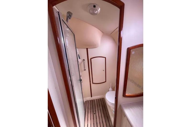 Slide: The Image of 2006 Hunter 36 yacht bathroom with shower, wooden flooring, and compact design. - 21