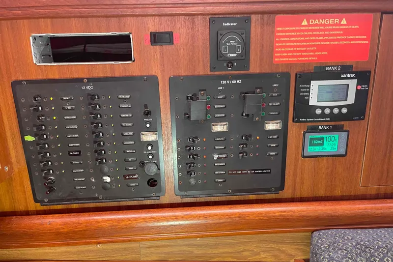Slide: The Image of Electrical control panel on a 2006 Hunter 36 sailboat, featuring various switches and indicators. - 23