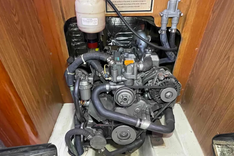 Slide: The Image of Engine compartment of a 2006 Hunter 36 sailboat, showcasing mechanical components. - 26