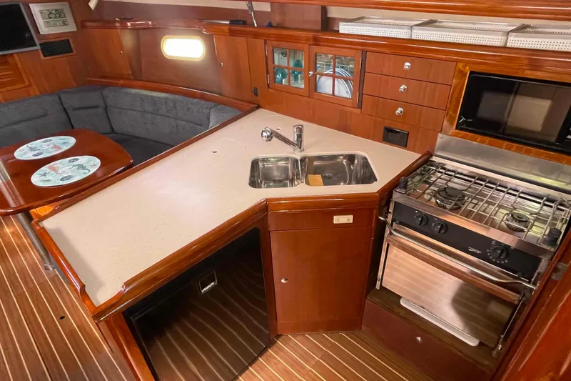 Slide: The Image of Interior of 2006 Hunter 36 yacht with kitchen and dining area. - 32