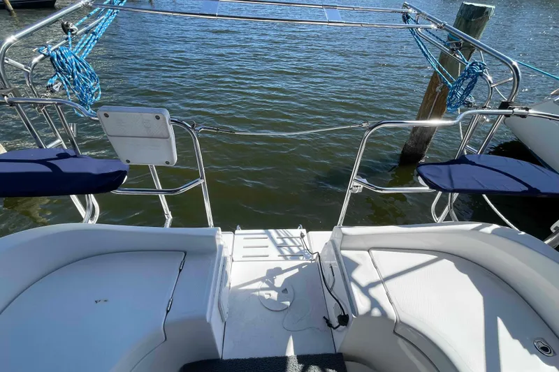 Slide: The Image of Hunter 36 sailboat stern view, 2006 model, docked with blue ropes and cushioned seats. - 37