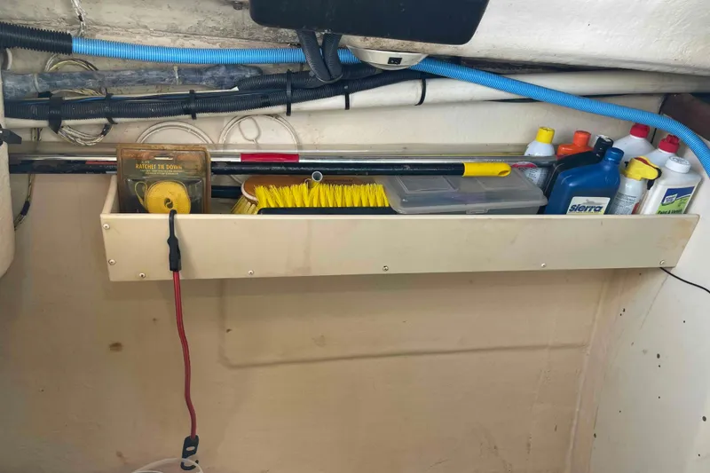 Slide: The Image of Storage shelf on a 2006 Hunter 36 boat with cleaning supplies and tools. - 45