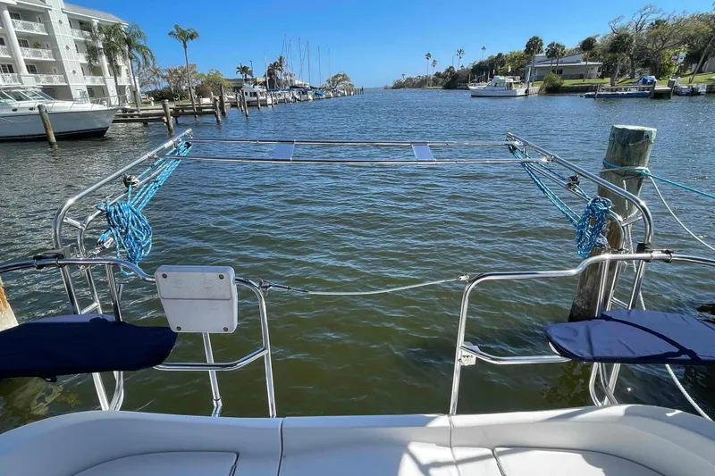 Slide: The Image of Hunter 36 sailboat stern view, docked in a scenic marina, 2006 model. - 47