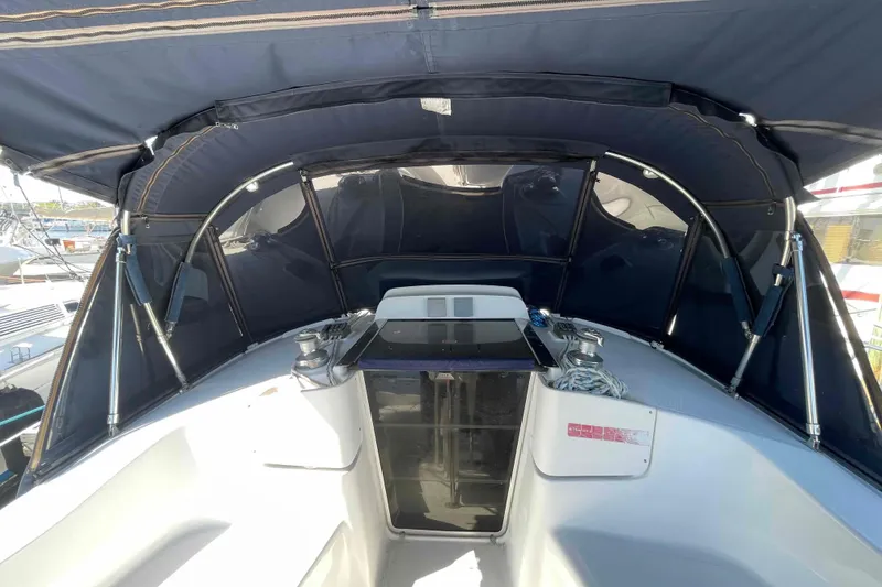 Slide: The Image of Cockpit of 2006 Hunter 36 sailboat with blue canopy and winches. - 57
