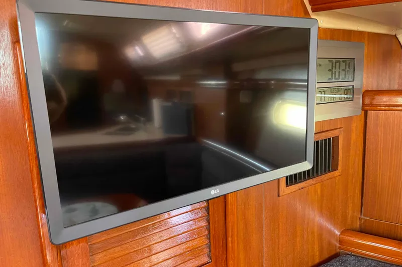 Slide: The Image of Flat-screen TV and digital clock inside 2006 Hunter 36 yacht cabin. - 7