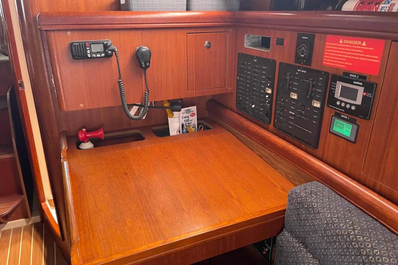 Slide: The Image of Interior of a 2006 Hunter 36 sailboat with navigation and control panels. - 9