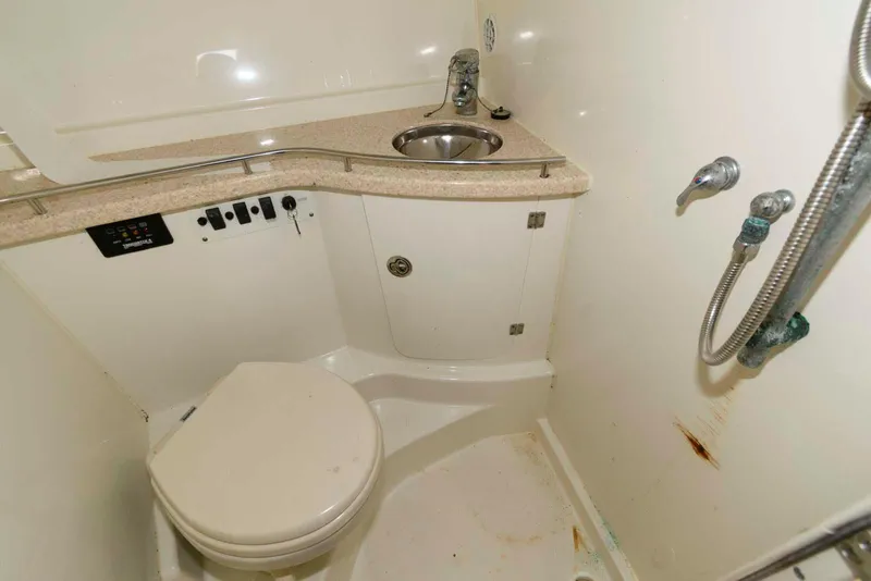 Slide: The Image of 2008 Hydra-Sports Vector 3500 VX boat bathroom with sink, toilet, and showerhead. - 21