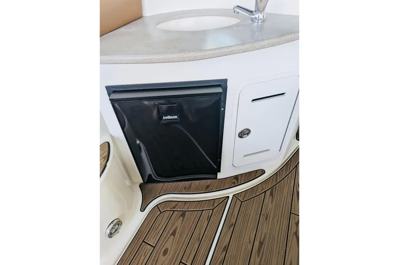 Slide: The Image of 2002 Sea Ray Sundancer 320 interior with sink, cabinet, and wood-patterned flooring. - 10