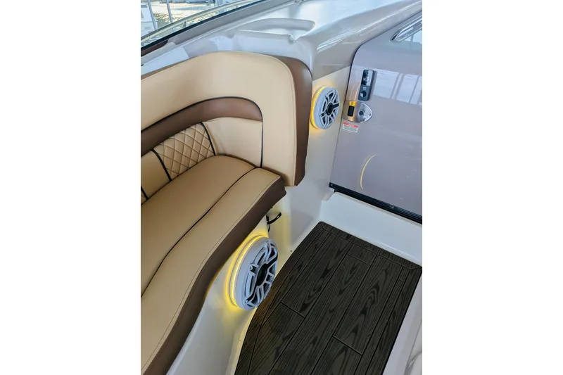 Slide: The Image of Luxurious interior of 2002 Sea Ray Sundancer 320 with cushioned seating and speaker system. - 14