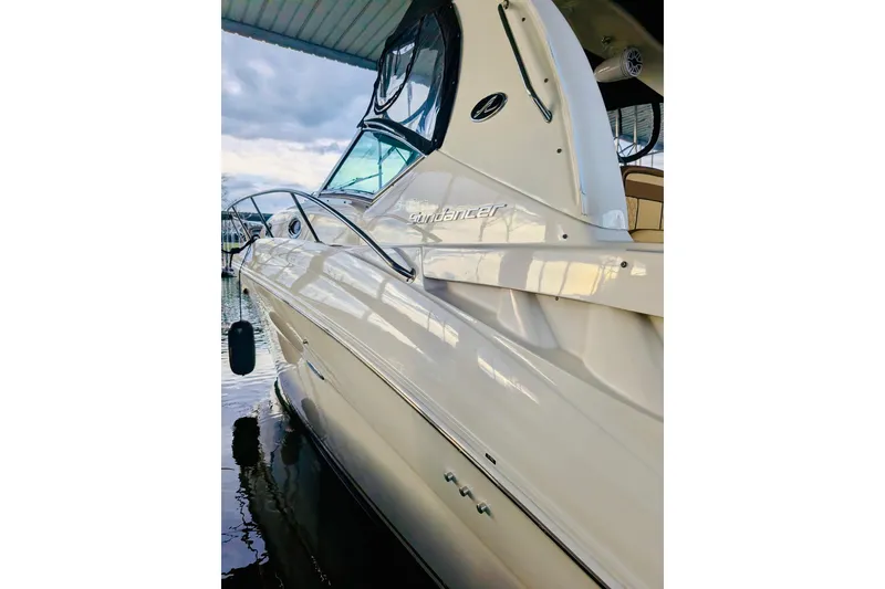 Slide: The Image of 2002 Sea Ray Sundancer 320 docked, showcasing sleek design and elegant curves. - 19