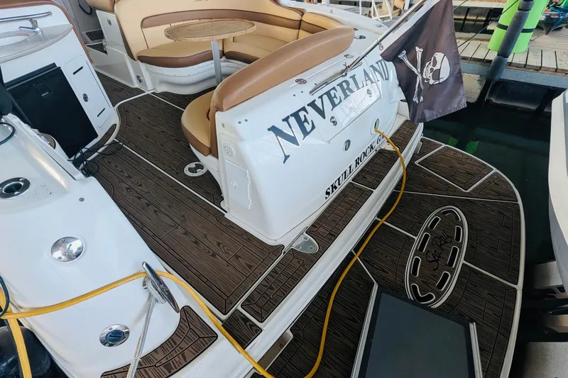 Slide: The Image of 2002 Sea Ray Sundancer 320 boat interior with wood flooring and seating area. - 2