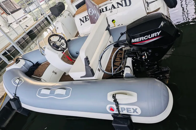 Slide: The Image of Inflatable boat with Mercury motor docked beside Sea Ray Sundancer 320, 2002 model. - 24