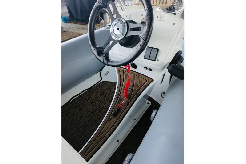 Slide: The Image of 2002 Sea Ray Sundancer 320 cockpit with steering wheel and wood accents. - 25