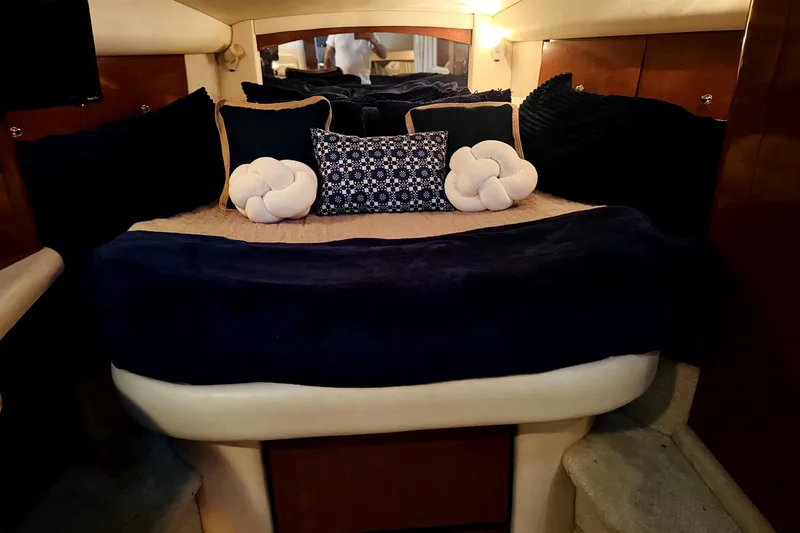 Slide: The Image of Luxurious cabin interior of 2002 Sea Ray Sundancer 320 with plush bedding and cushions. - 32