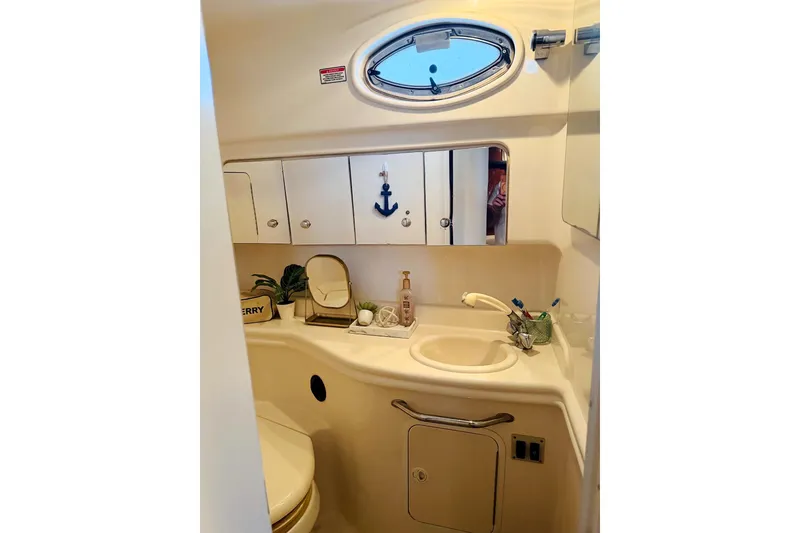 Slide: The Image of 2002 Sea Ray Sundancer 320 bathroom with sink, mirror, and nautical decor. - 33