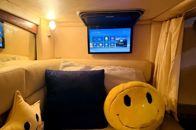 Slide: The Image of Cozy interior of 2002 Sea Ray Sundancer 320 with TV and smiley face pillow. - 35