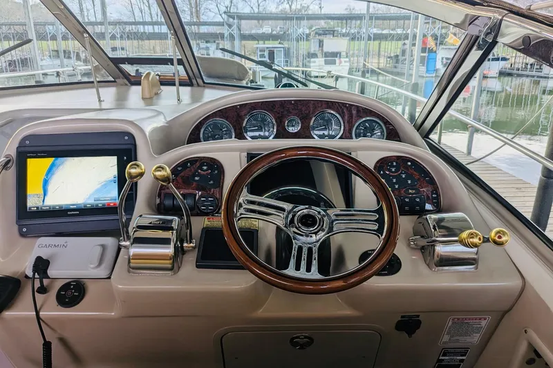Slide: The Image of 2002 Sea Ray Sundancer 320 helm with Garmin navigation and classic wood steering wheel. - 5