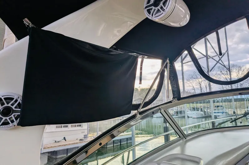 Slide: The Image of 2002 Sea Ray Sundancer 320 interior with speakers and marina view. - 7