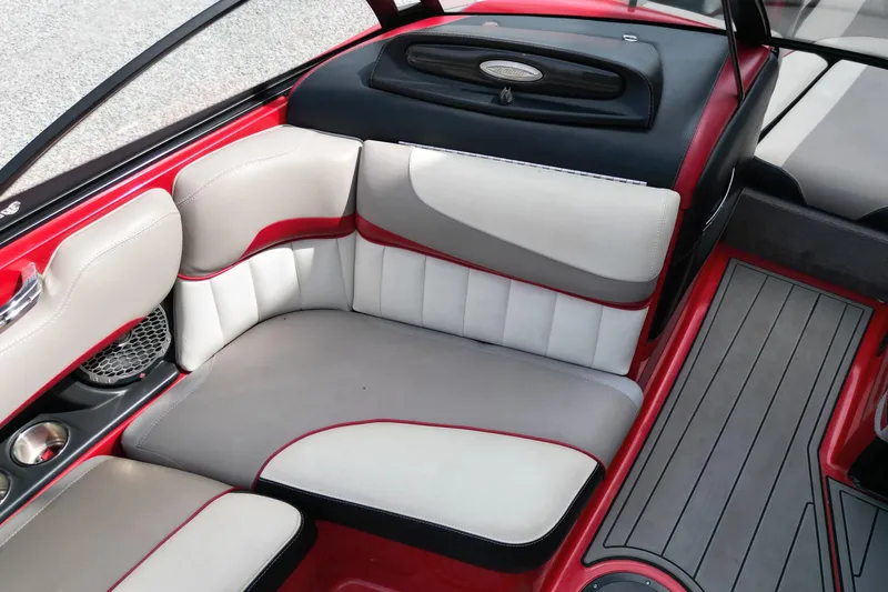 Slide: The Image of 2012 Malibu Wakesetter 22 MXZ interior with red and white seating and sleek design. - 12