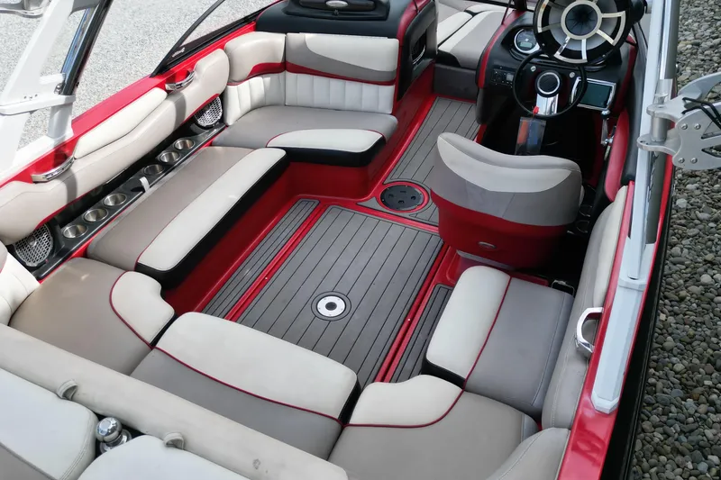 Slide: The Image of 2012 Malibu Wakesetter 22 MXZ interior with red and beige seating, sleek design. - 13
