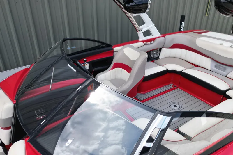 Slide: The Image of 2012 Malibu Wakesetter 22 MXZ interior with red and white seating, sleek design. - 14