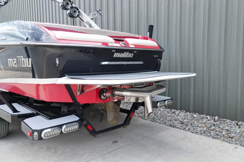 Slide: The Image of 2012 Malibu Wakesetter 22 MXZ boat rear view, featuring sleek design and advanced wakeboarding features. - 15