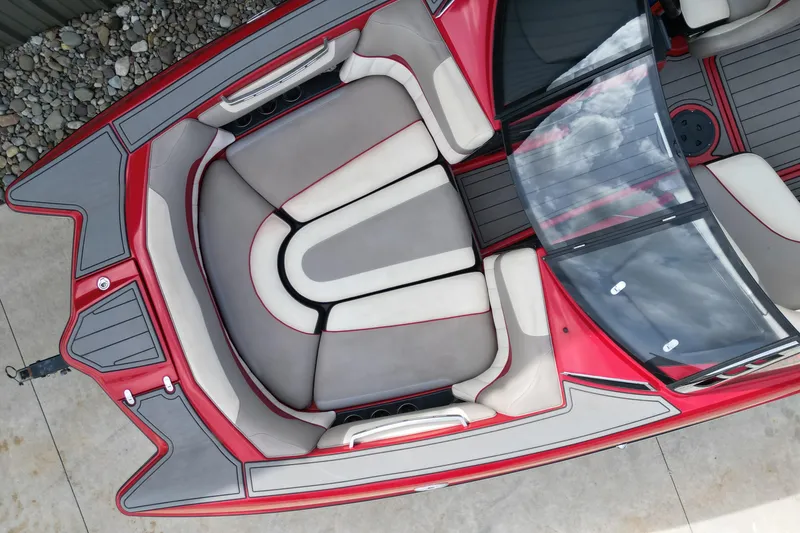 Slide: The Image of 2012 Malibu Wakesetter 22 MXZ boat interior with red and gray seating. - 4