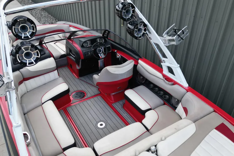 Slide: The Image of 2012 Malibu Wakesetter 22 MXZ interior with red and white seating, advanced sound system. - 6
