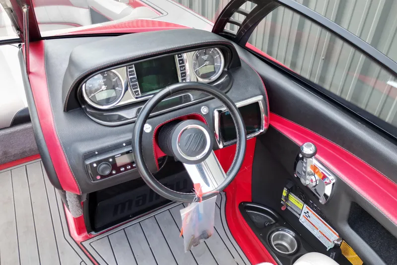 Slide: The Image of 2012 Malibu Wakesetter 22 MXZ dashboard with steering wheel and controls. - 8