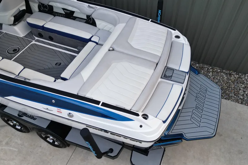 Slide: The Image of 2017 Malibu Wakesetter 25 LSV boat interior with white and blue seating. - 4