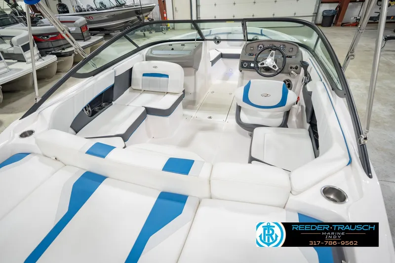 Slide: The Image of 2015 Regal 2000 ESX Bowrider interior with white and blue seating, steering wheel, and dashboard. - 14