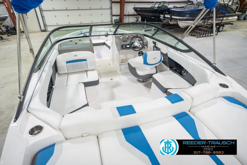 Slide: The Image of 2015 Regal 2000 ESX Bowrider interior with white and blue seating in showroom. - 15