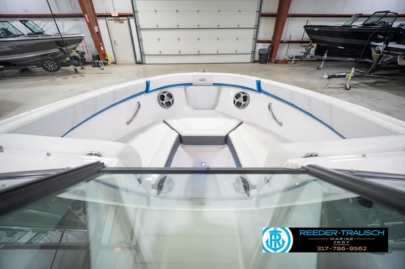 Slide: The Image of 2015 Regal 2000 ESX Bowrider interior in showroom, featuring white seating and blue accents. - 18