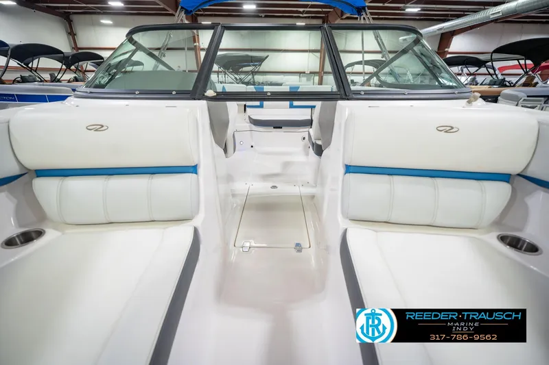 Slide: The Image of 2015 Regal 2000 ESX Bowrider interior with white and blue seating in showroom. - 19