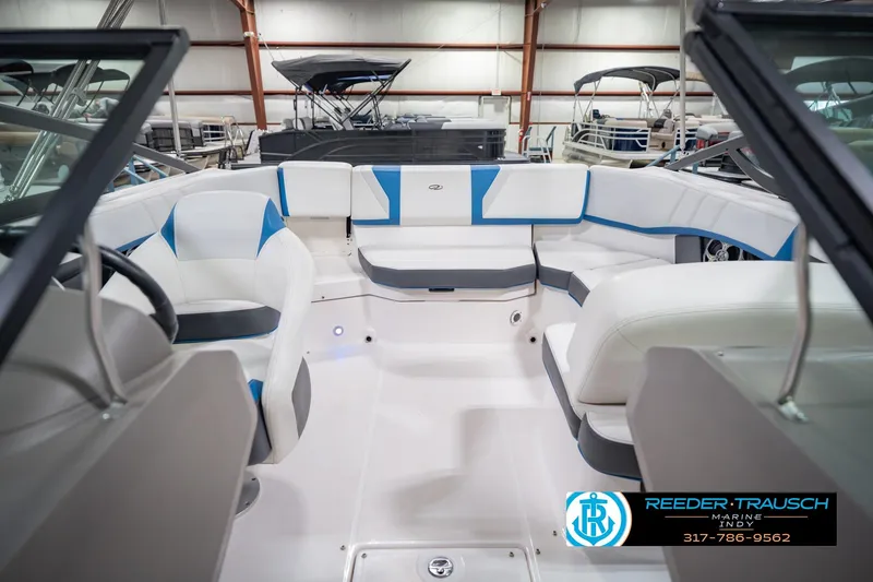 Slide: The Image of 2015 Regal 2000 ESX Bowrider interior with white and blue seating in showroom. - 20